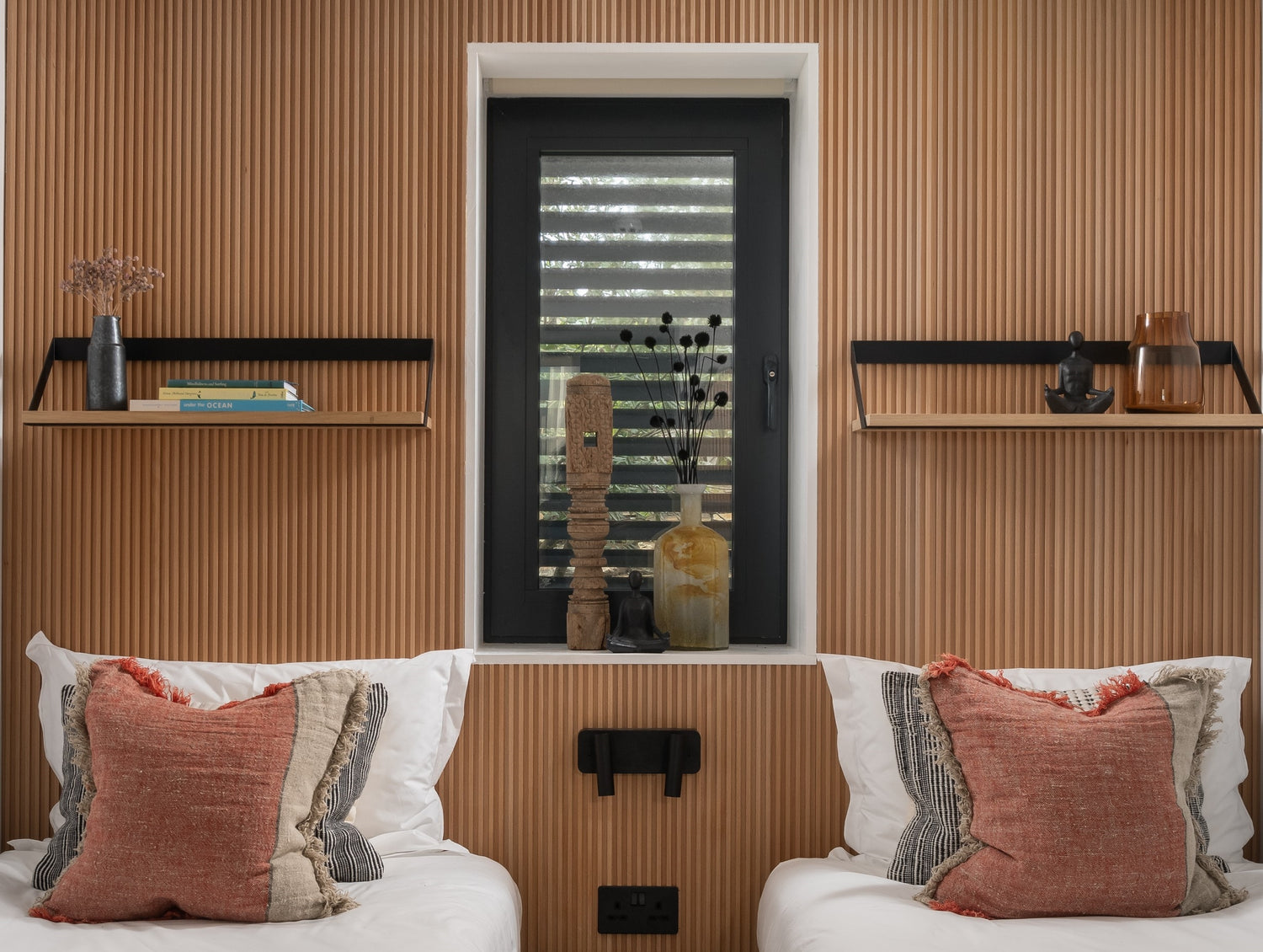 Two beds in a bedroom with a minimal Japandi-style decor. Annex Beech flute wood wall panels by element
