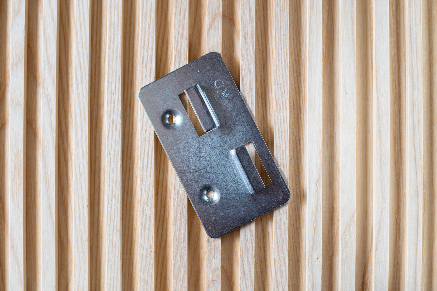 Thumbnail of metal fixing bracket on top of fluted wall panel.