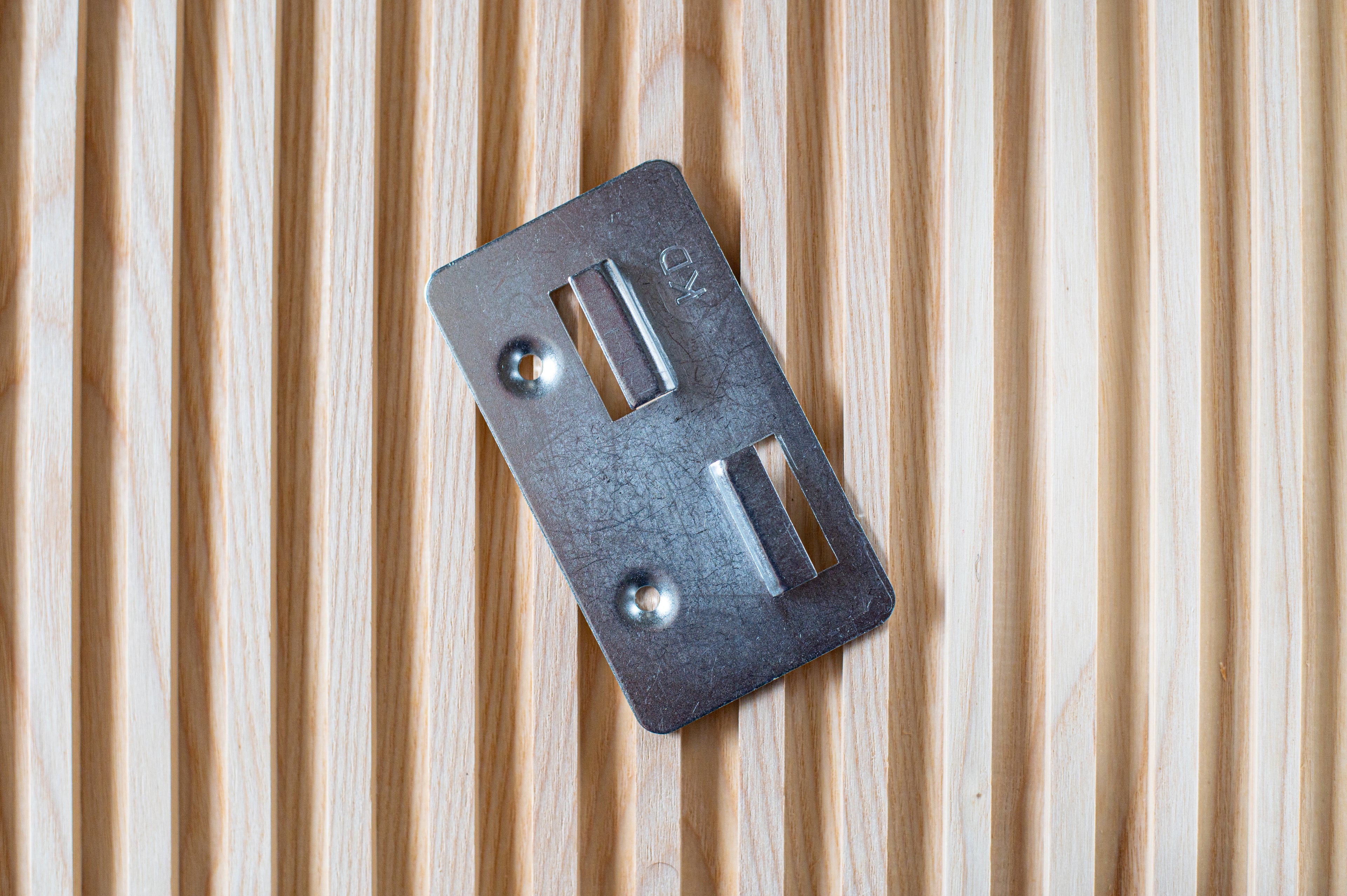 Thumbnail of metal fixing bracket on top of fluted wall panel.