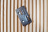 Thumbnail of metal fixing bracket on top of fluted wall panel.