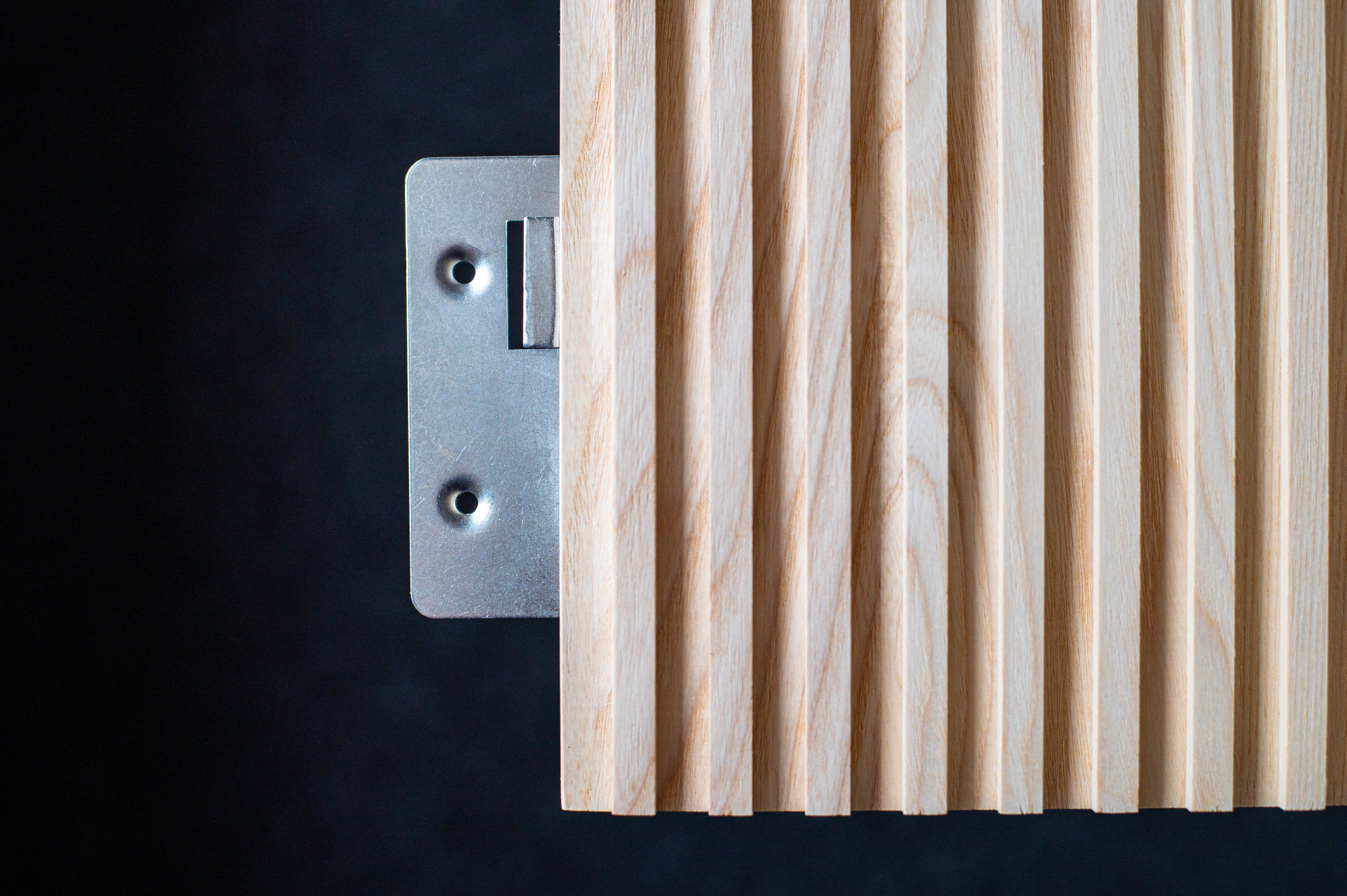 Close up metal fixing of fluted wall panel by Element